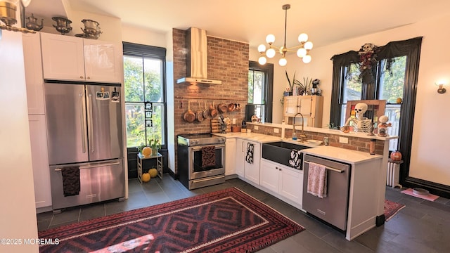 130 Main St, Keyport, NJ 07735 - kitchen featuring stainless steel appliances, wall chimney exhaust hood, a sink, a peninsula, and healthy amount of natural light