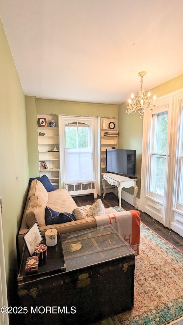 130 Main St, Keyport, NJ 07735 - living area with a chandelier, plenty of natural light, and wood finished floors