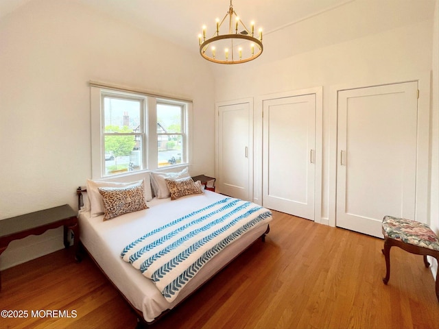 1 Roseld Ct, Deal, NJ 07723 - bedroom with a chandelier, light wood-style flooring, and multiple closets