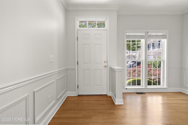 14 Osprey Ln Unit 72, Bayville, NJ 08721 - entryway featuring wood finished floors, crown molding, a decorative wall, and a wainscoted wall