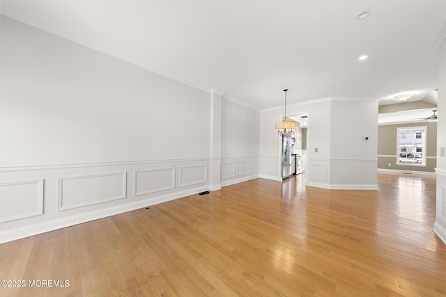 14 Osprey Ln Unit 72, Bayville, NJ 08721 - spare room featuring light wood finished floors, ornamental molding, a chandelier, wainscoting, and recessed lighting