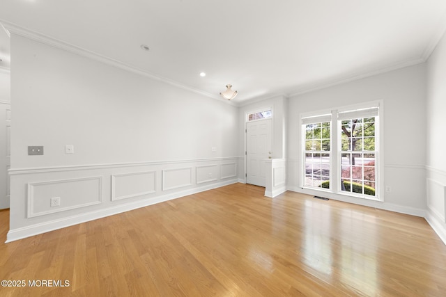 14 Osprey Ln Unit 72, Bayville, NJ 08721 - unfurnished room featuring crown molding, light wood-type flooring, a decorative wall, a wainscoted wall, and recessed lighting