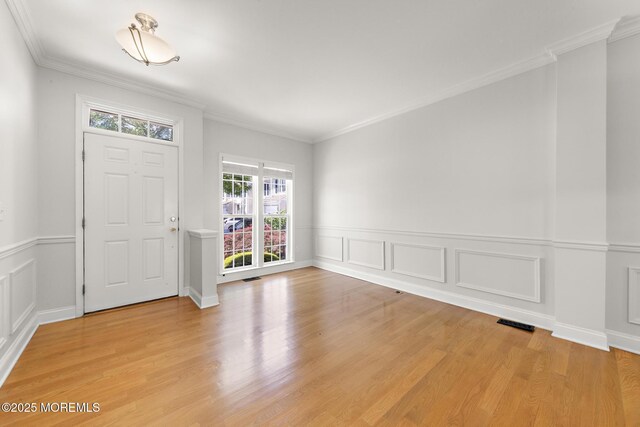 14 Osprey Ln Unit 72, Bayville, NJ 08721 - entryway with ornamental molding, light wood finished floors, a wainscoted wall, and a decorative wall