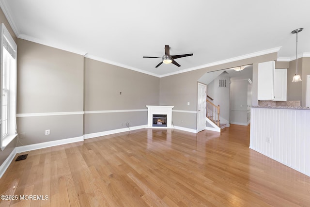 14 Osprey Ln Unit 72, Bayville, NJ 08721 - unfurnished living room featuring ceiling fan, light wood-style floors, stairs, a glass covered fireplace, and baseboards