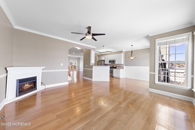 14 Osprey Ln Unit 72, Bayville, NJ 08721 - unfurnished living room with crown molding, a glass covered fireplace, ceiling fan, light wood-style flooring, and baseboards