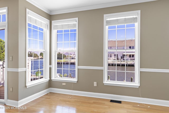 14 Osprey Ln Unit 72, Bayville, NJ 08721 - empty room featuring baseboards, wood finished floors, a water view, and crown molding