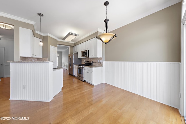 14 Osprey Ln Unit 72, Bayville, NJ 08721 - kitchen featuring appliances with stainless steel finishes, backsplash, white cabinets, light wood-type flooring, and ornamental molding