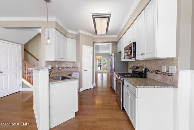 14 Osprey Ln Unit 72, Bayville, NJ 08721 - kitchen with stainless steel appliances, a sink, light stone counters, white cabinetry, and ornamental molding