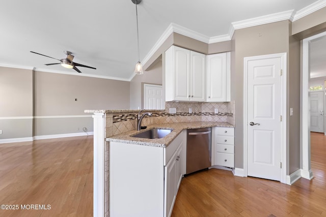 14 Osprey Ln Unit 72, Bayville, NJ 08721 - kitchen featuring dishwasher, a sink, a peninsula, decorative backsplash, and light wood finished floors