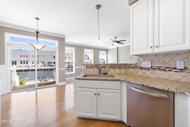 14 Osprey Ln Unit 72, Bayville, NJ 08721 - kitchen featuring stainless steel dishwasher, a sink, decorative backsplash, ceiling fan, and crown molding