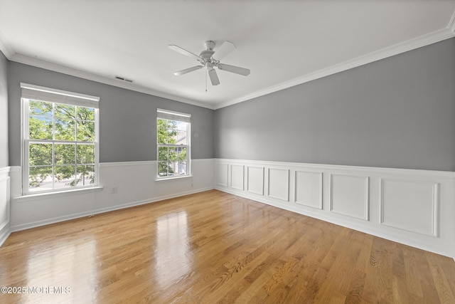 14 Osprey Ln Unit 72, Bayville, NJ 08721 - unfurnished room with wainscoting, a ceiling fan, light wood-type flooring, and crown molding