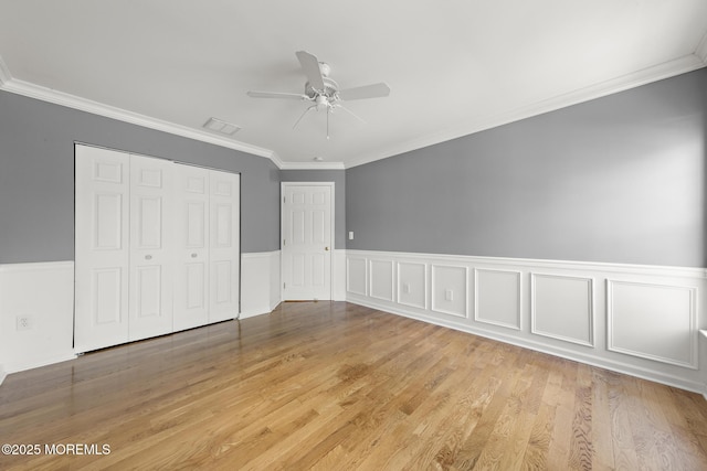 14 Osprey Ln Unit 72, Bayville, NJ 08721 - unfurnished bedroom with crown molding, a closet, light wood-style floors, ceiling fan, and a wainscoted wall