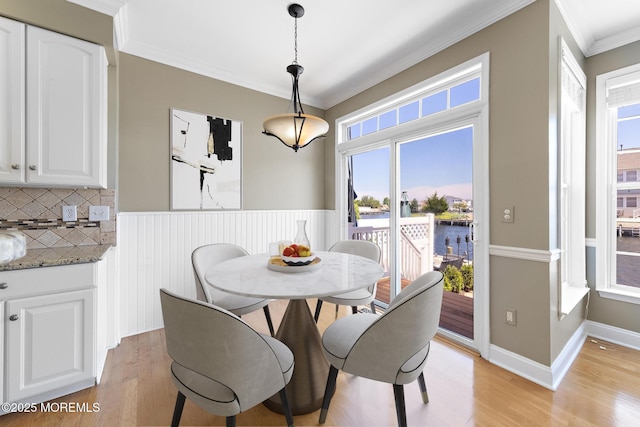 14 Osprey Ln Unit 72, Bayville, NJ 08721 - dining area with a water view, crown molding, light wood-style flooring, and healthy amount of natural light