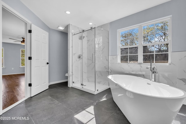 19 Hillside Ave, Barnegat, NJ 08005 - full bathroom featuring tile walls, a marble finish shower, a soaking tub, recessed lighting, and a wainscoted wall