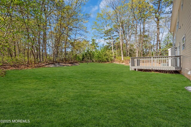 19 Hillside Ave, Barnegat, NJ 08005 - view of green lawn with a wooden deck