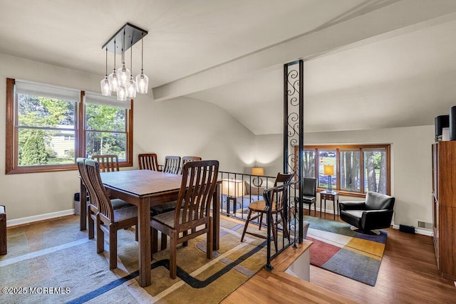 2 Merrick Ct, Middletown, NJ 07748 - dining space with healthy amount of natural light, baseboards, lofted ceiling, wood finished floors, and a chandelier