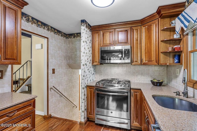 2 Merrick Ct, Middletown, NJ 07748 - kitchen with appliances with stainless steel finishes, a sink, wood finished floors, baseboards, and brown cabinets