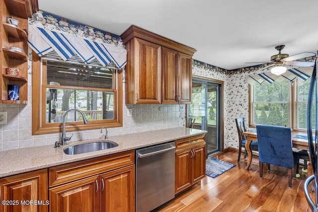 2 Merrick Ct, Middletown, NJ 07748 - kitchen featuring dishwasher, a sink, light wood-type flooring, brown cabinets, and wallpapered walls
