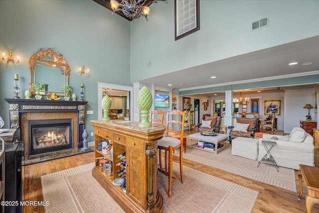68 Seneca Pl, Oceanport, NJ 07757 - dining space with a chandelier, a glass covered fireplace, a towering ceiling, and wood finished floors