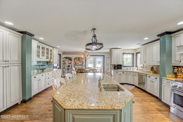 68 Seneca Pl, Oceanport, NJ 07757 - kitchen with appliances with stainless steel finishes, a sink, an island with sink, recessed lighting, and light stone countertops