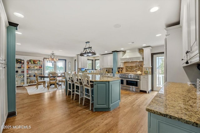 68 Seneca Pl, Oceanport, NJ 07757 - kitchen with double oven range, custom exhaust hood, light wood-style floors, a kitchen island with sink, and decorative backsplash