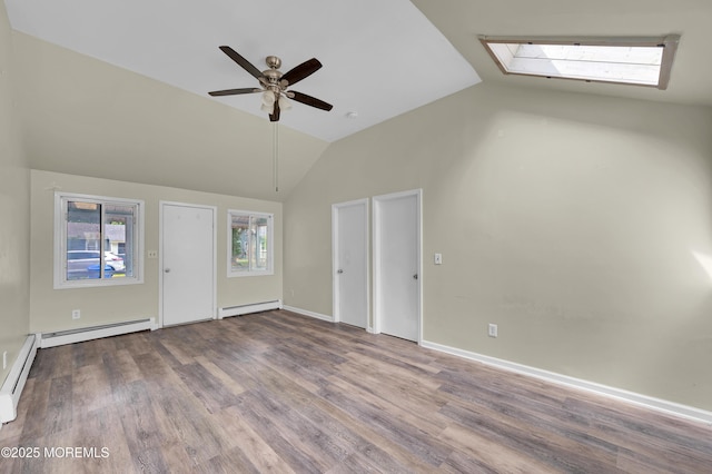 90 Dock Rd, Brick, NJ 08723 - unfurnished living room featuring a baseboard heating unit, vaulted ceiling, wood finished floors, a skylight, and ceiling fan