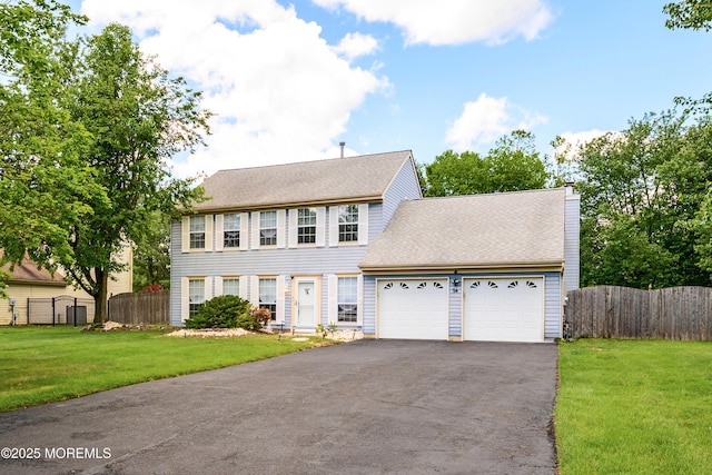 14 Winfield Dr, Manalapan, NJ 07726 - colonial inspired home featuring a garage, asphalt driveway, and a shingled roof