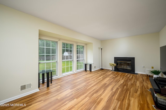 14 Winfield Dr, Manalapan, NJ 07726 - unfurnished living room with light wood finished floors, a glass covered fireplace, and baseboards