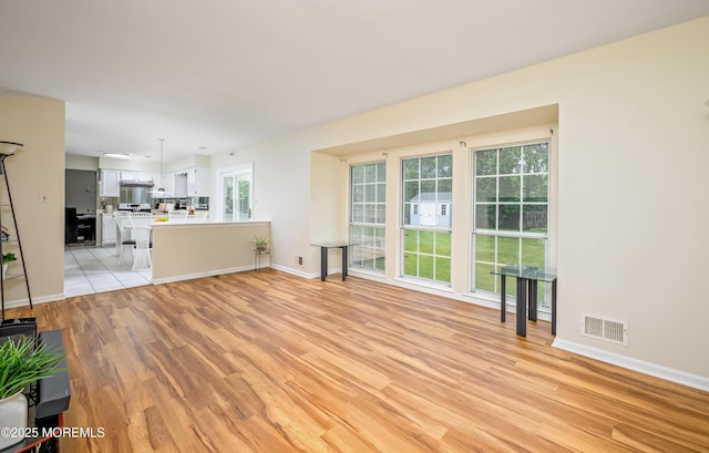 14 Winfield Dr, Manalapan, NJ 07726 - unfurnished living room with light wood finished floors and baseboards