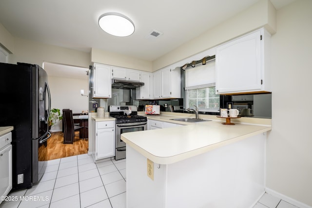 14 Winfield Dr, Manalapan, NJ 07726 - kitchen with gas range, freestanding refrigerator, a sink, under cabinet range hood, and a peninsula
