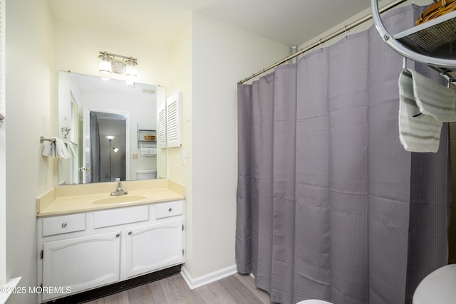 14 Winfield Dr, Manalapan, NJ 07726 - full bathroom featuring wood finished floors, toilet, vanity, a shower with shower curtain, and baseboards