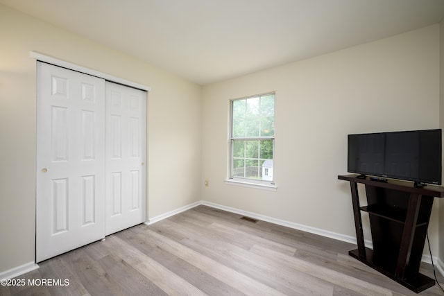 14 Winfield Dr, Manalapan, NJ 07726 - unfurnished bedroom featuring wood finished floors, baseboards, and a closet