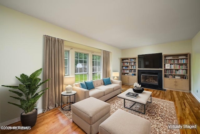 14 Winfield Dr, Manalapan, NJ 07726 - living room with wood finished floors, a glass covered fireplace, and baseboards