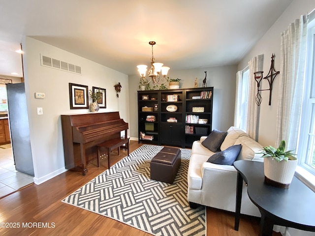 8 Augusta St, Wrightstown, NJ 08562 - living area with a chandelier, wood finished floors, and baseboards