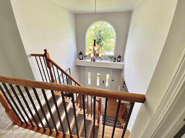 8 Augusta St, Wrightstown, NJ 08562 - staircase featuring a chandelier, a towering ceiling, and wood finished floors