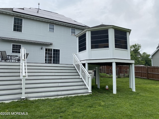 8 Augusta St, Wrightstown, NJ 08562 - rear view of property with a sunroom, solar panels, and stairway