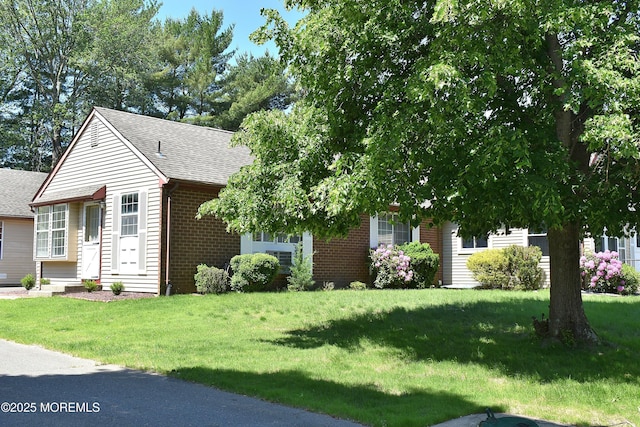 29A Easton Dr Unit 61, Whiting, NJ 08759 - view of front of house featuring brick siding, roof with shingles, and a front yard