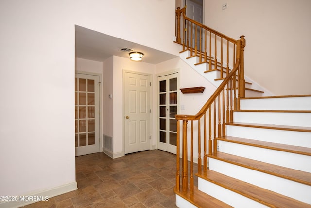 153 12th St, Belford, NJ 07718 - entrance foyer with stone finish flooring, stairway, baseboards, and french doors