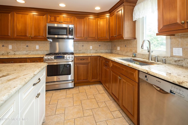 153 12th St, Belford, NJ 07718 - kitchen featuring appliances with stainless steel finishes, a sink, brown cabinets, and recessed lighting