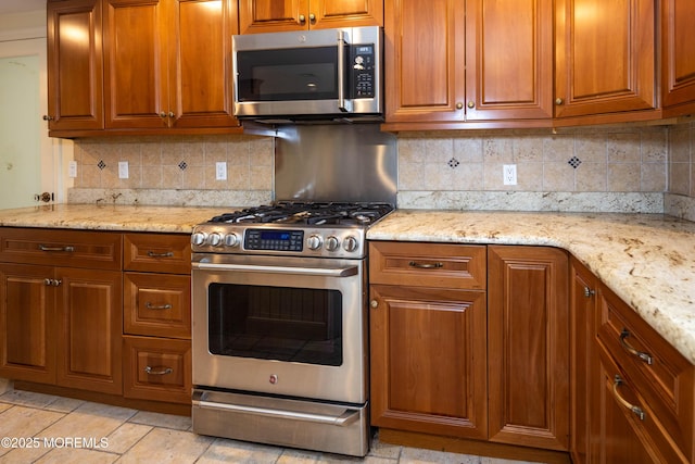 153 12th St, Belford, NJ 07718 - kitchen featuring appliances with stainless steel finishes, brown cabinetry, and tasteful backsplash