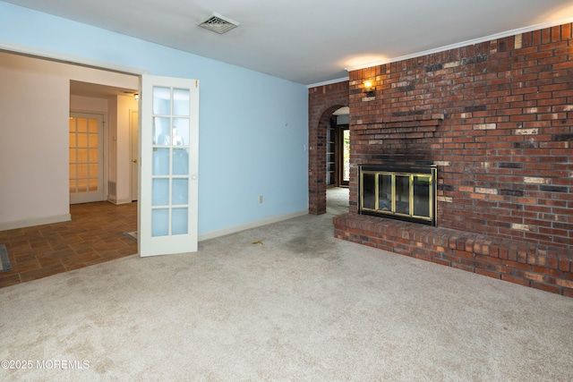 153 12th St, Belford, NJ 07718 - unfurnished living room featuring arched walkways, carpet floors, a fireplace, and baseboards