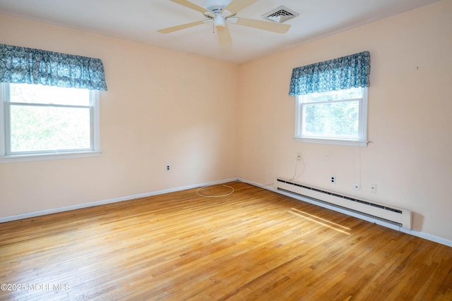 153 12th St, Belford, NJ 07718 - spare room featuring a baseboard heating unit, wood finished floors, ceiling fan, and baseboards