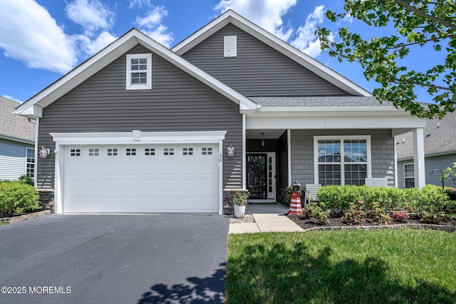 56 Butler Dr, Barnegat, NJ 08005 - view of front of property with asphalt driveway, a garage, stone siding, a porch, and a shingled roof