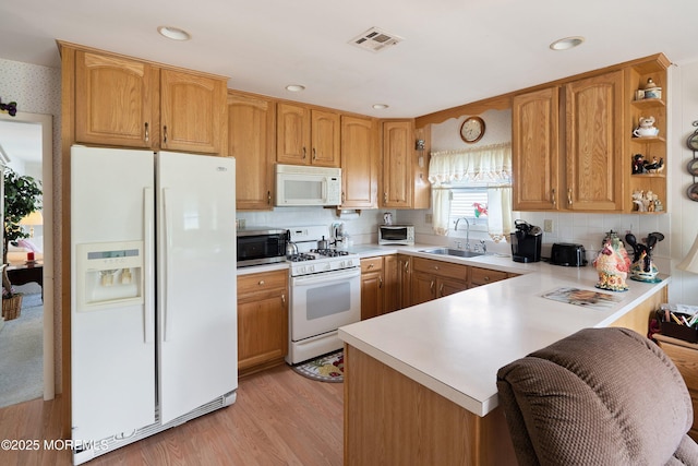 14 Tijuana Ct, Toms River, NJ 08757 - kitchen with white appliances, a sink, a peninsula, light countertops, and light wood finished floors