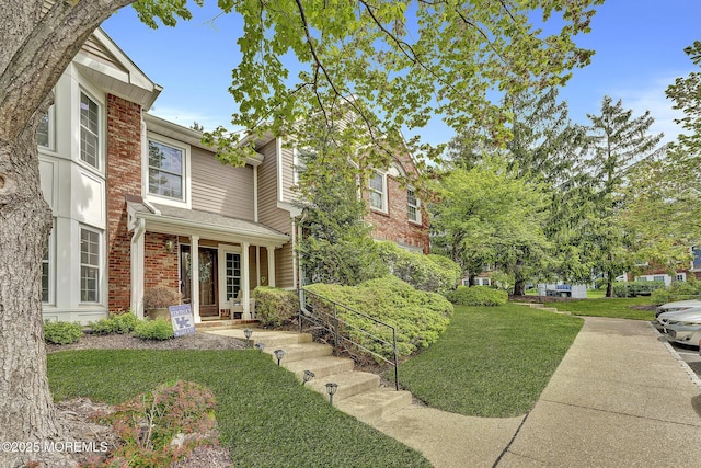 43 Woodledge Ct, Rockaway Twp, NJ 07866 - view of front facade featuring brick siding and a front yard