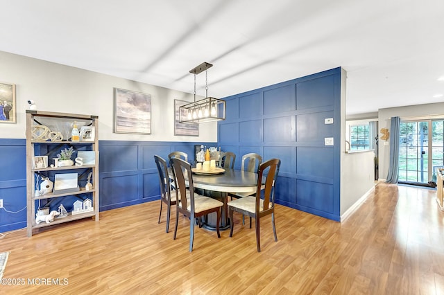 43 Woodledge Ct, Rockaway Twp, NJ 07866 - dining room featuring a decorative wall, light wood-type flooring, and wainscoting