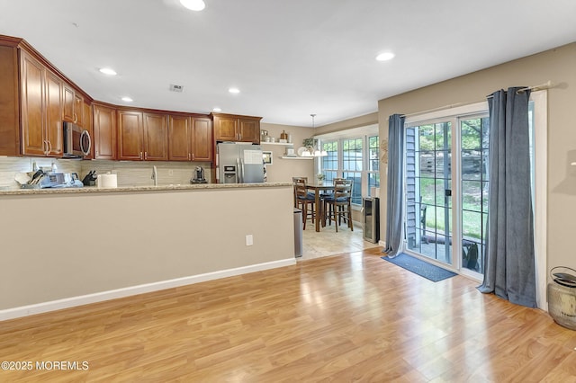 43 Woodledge Ct, Rockaway Twp, NJ 07866 - kitchen with stainless steel appliances, decorative backsplash, recessed lighting, a peninsula, and light wood-style floors