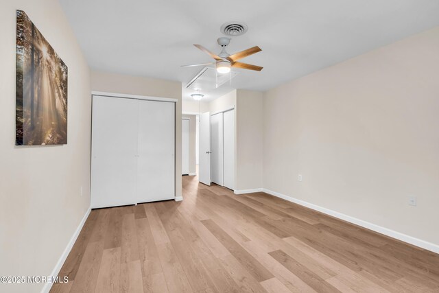 28 Mill Rd Unit B, Whiting, NJ 08759 - unfurnished bedroom with two closets, light wood-type flooring, baseboards, and ceiling fan