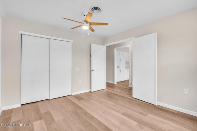 28 Mill Rd Unit B, Whiting, NJ 08759 - unfurnished bedroom featuring light wood-type flooring, white fridge with ice dispenser, and baseboards
