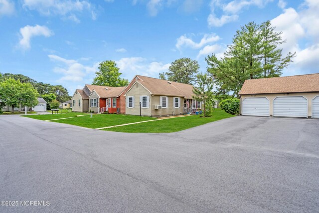 28 Mill Rd Unit B, Whiting, NJ 08759 - view of front of home with a front lawn, a detached garage, and a residential view